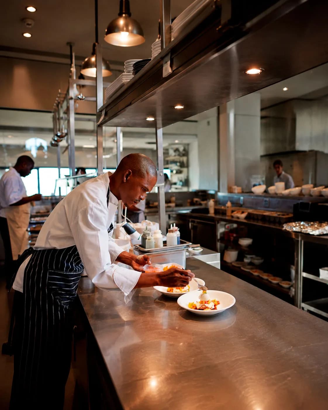 A restaurant and catering team preparing dishes in a professional kitchen